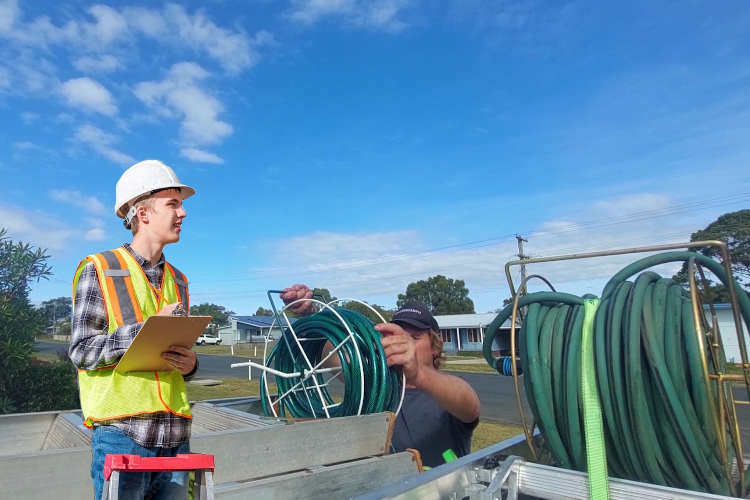 
nowra gutter cleaner readies his hoses after completing thorough rinsing.